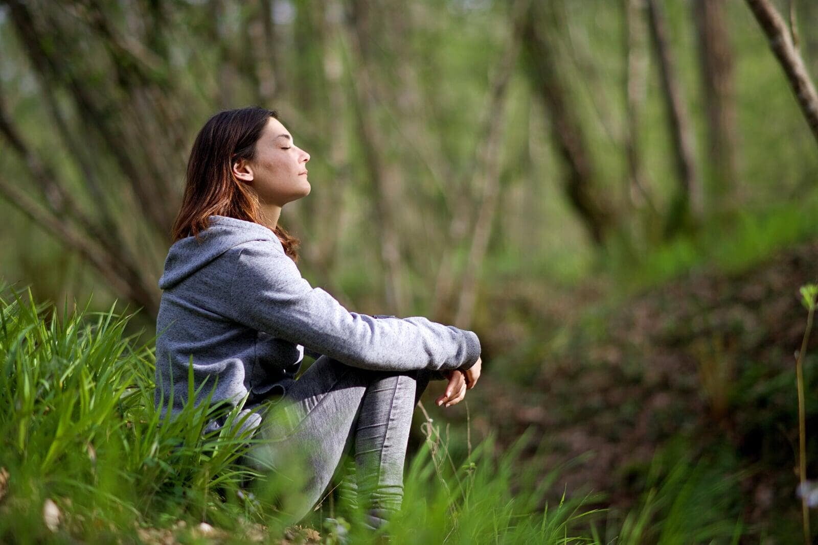 woman sitting in forest