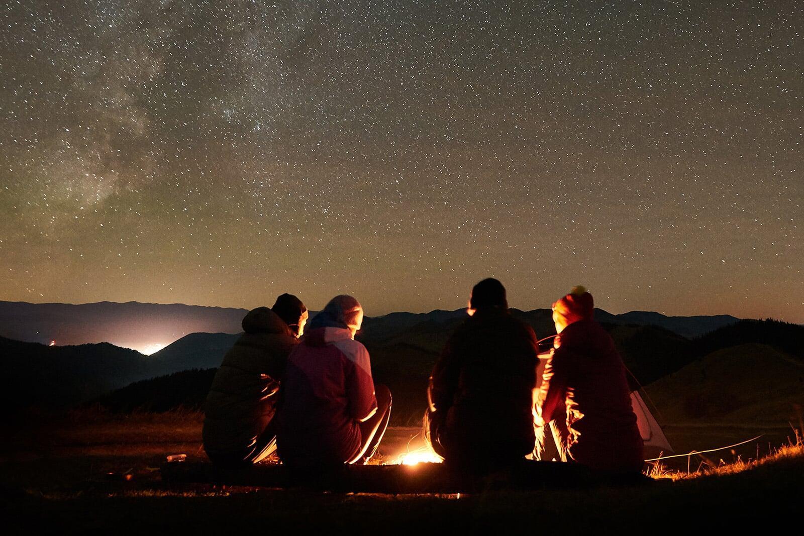 friends sitting around a campfire